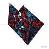 A vibrant red and blue doodle-style graffiti laptop skin sticker applied to the lid and palm rest of an open laptop.